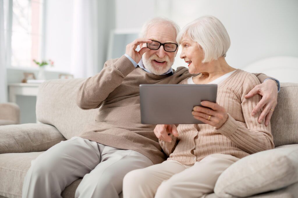 Elderly couple looking at a tab
